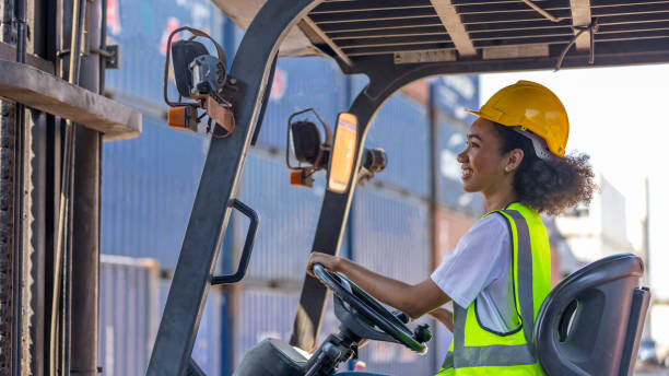 Young African American mechanical engineer with forklift