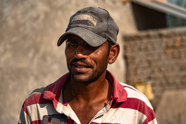 istock a poor laborer working hard in extreme heat on construction site 1370462914