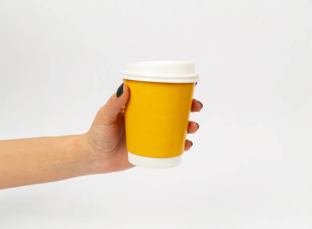 istock paper take away cup hand on white background 1370463298