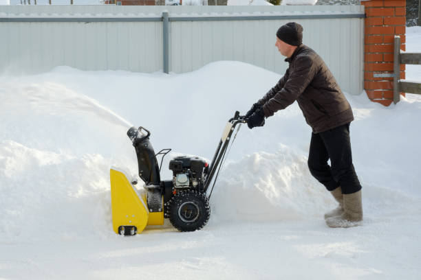 istock Man using snow plow machine to clear the inner courtyard in winter. Russia. 1370465907