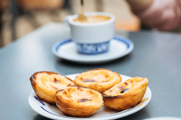 Egg custard dessert Pastel de Nata Traditional Portugese egg custard tart called pasteis de Belem. It is made from pastry dough and eggs with vanilla. It is oven baked and served with coffee. pasteis de belem stock pictures, royalty-free photos & images