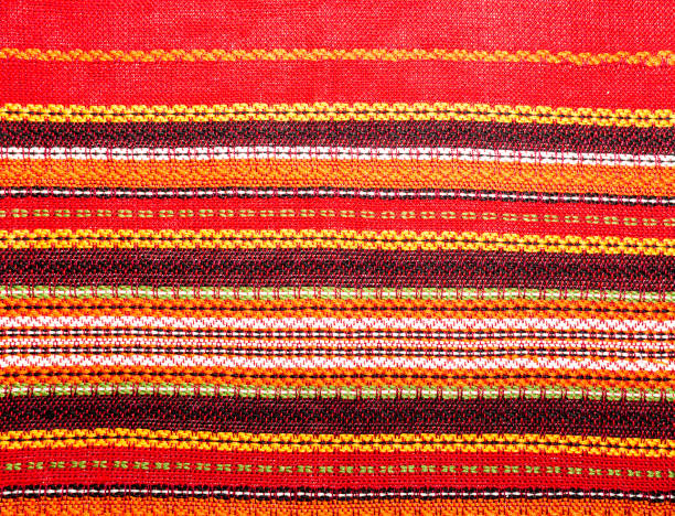 The texture, pattern. The background red, bright fabric with stripes close-up