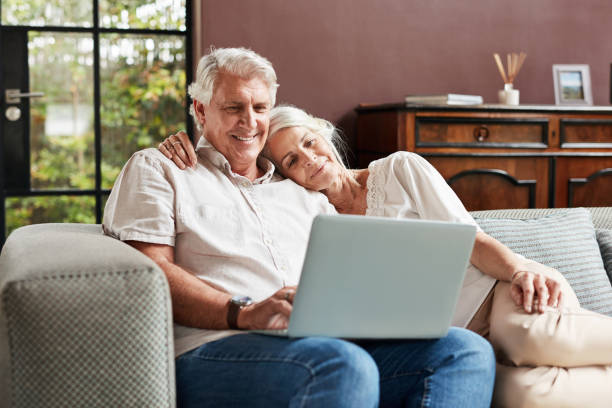 istock Shot of a mature couple using a laptop while relaxing together on a sofa at home 1370470710