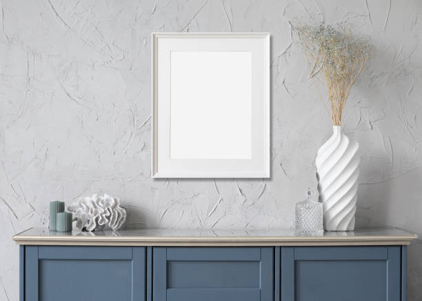 istock Artwork mock-up in interior design. Blank white vertical picture frame on a wall 1370472008