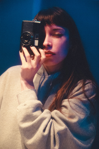 Young woman take analog photo selfie mirror