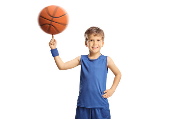 istock Boy in a blue jersey spinning a basketball 1370475190