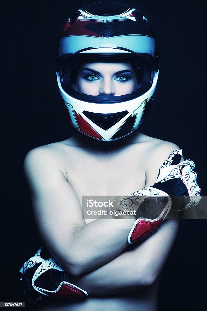 Woman in biker helmet Beautiful sexy woman with stylish makeup in biker helmet and gloves Adult Stock Photo