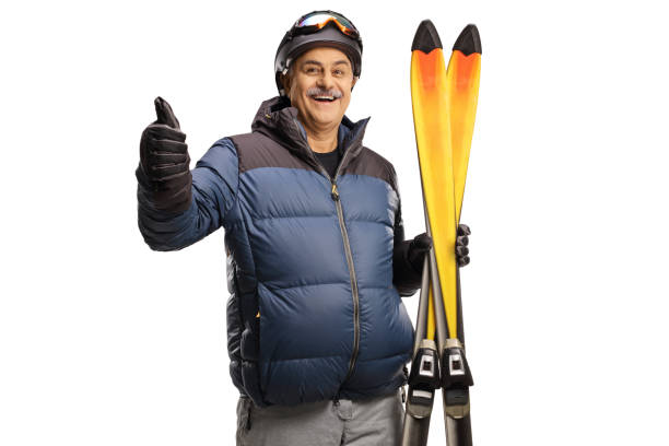 Mature man holding a pair of skis and gesturing thumbs up Mature man holding a pair of skis and gesturing thumbs up isolated on a white background thumbs up for skiing stock pictures, royalty-free photos & images