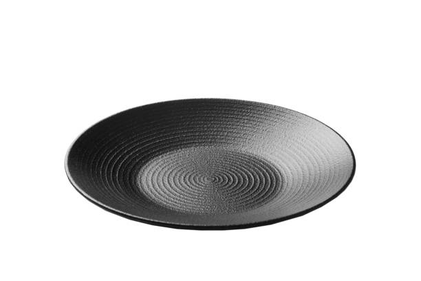 istock Black ceramic round plate isolated over white background. perspective view 1370476561