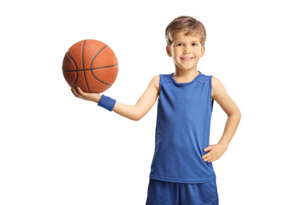 istock Smiling boy in a blue jersey holding a basketball 1370477921