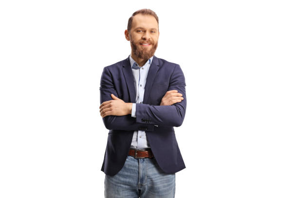 istock Young bearded man in a suit and jeans posing with crossed arms 1370477954