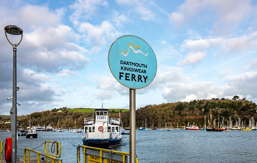 Dartmouth, UK. Ferry Sign in Dartmouth with the ferry mooring behind.