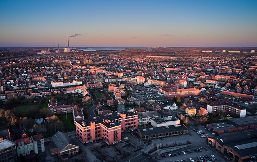 Aerial view of Odense. The local power plant is in the horizon. Bottom old factory buildings renovated for use as office buildings. \
