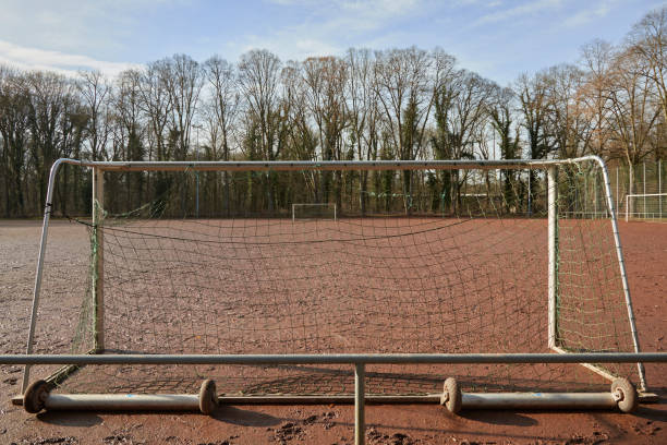 istock view through a goal to another on a cinder pith, red soccer field 1370483223