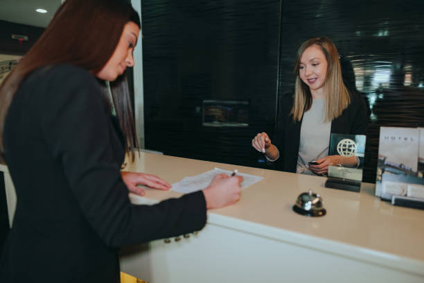 istock Businesswoman at the hotel reception checking-in 1370484538