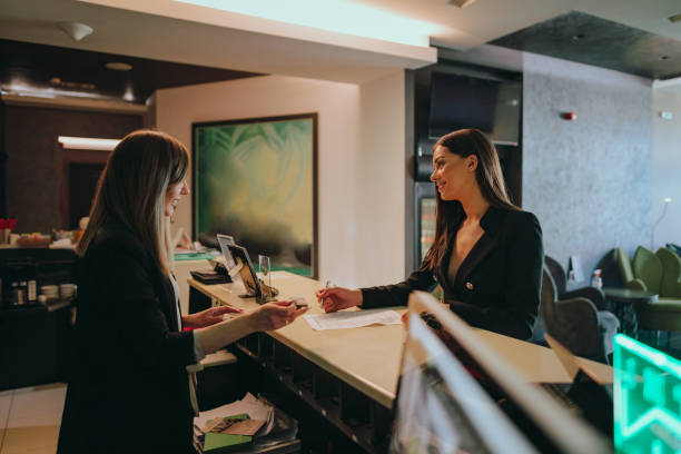 istock Businesswoman at the hotel reception checking-in 1370484685