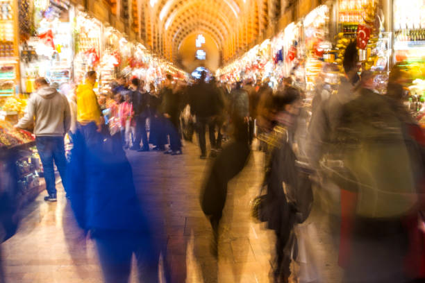 istock Crowd on blur street in bright lens flare 1370485481