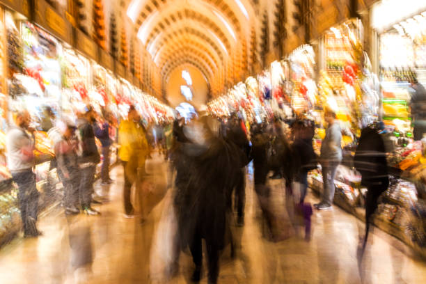 istock Crowd on blur street in bright lens flare 1370486105
