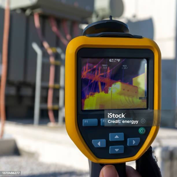Infrared Thermal Imaging Camera Pointing To Electrical Transformer Stock Photo - Download Image Now