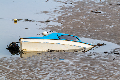 This is a small boat that has sunk and started to break up within the harbour at Portgordon, Moray, Scotland on 13 February 2022