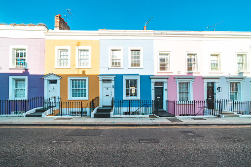 Colorful English houses facades, pastel pale colors in London