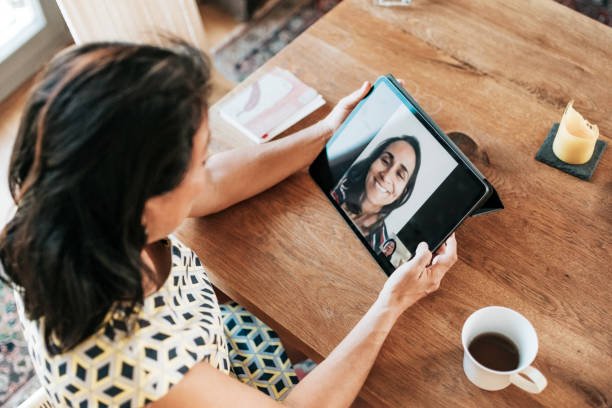 istock elegant woman having video call on digital tablet 1370487853