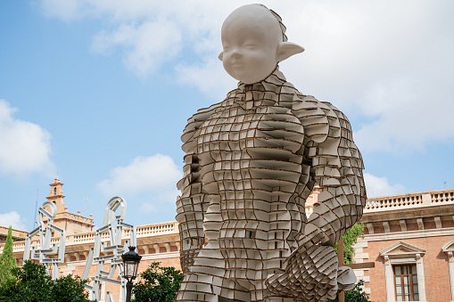 Valencia, Spain - 4 September 2021: Figurine for the national festival Fallas with the original paper structure at 'Placa del Col-legi del Patriarca'