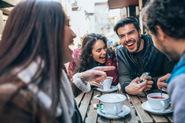 istock Friends talking and laughing in a cafe 1370491338