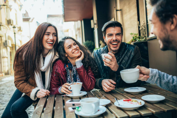 istock Friends talking and laughing in a cafe 1370491340