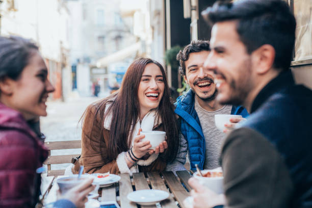 istock Friends talking and laughing in a cafe 1370491343