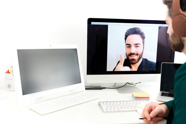 istock young man connected online with video call for work from home. telecommuting. 1370492460