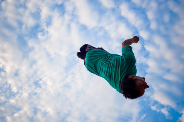 istock Parkour man doing backflip in the air 1370493811