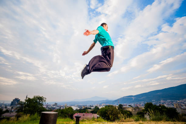 istock Young parkour man jumping in nature 1370493871