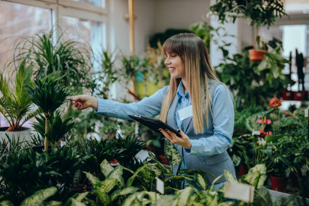 istock Woman working in the flower shop using a digital tablet 1370495037