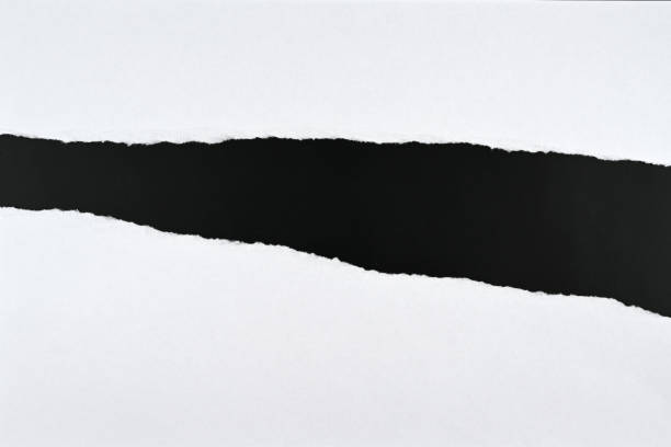 istock Strips of white paper on a black table 1370499161