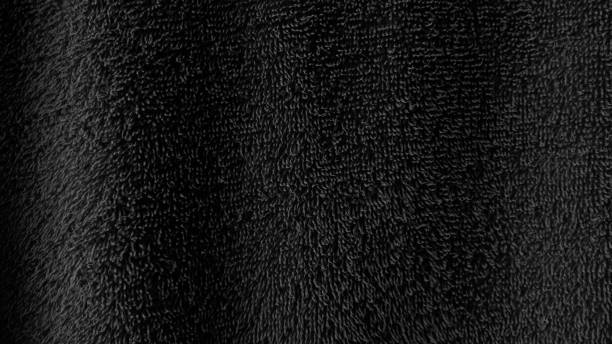 istock Black luxury soft fluffy fabric texture background with copy space 1370499597