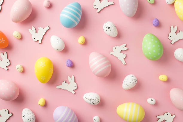 istock Top view photo of easter decorations easter bunnies and multicolored eggs on isolated pastel pink background 1370502425