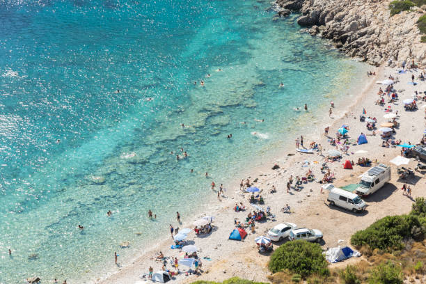 people camping and vacationing by the sea