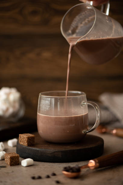 istock hot sweet chocolate cocoa is poured into a glass cup 1370504569