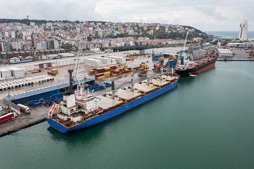 Aerial view of cargo ship at port.