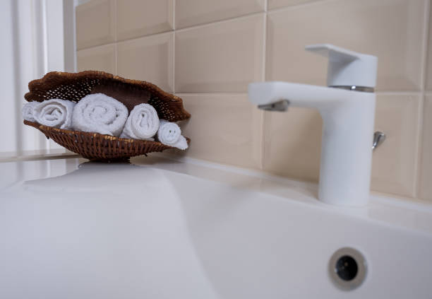 istock Terry white and brown towels in a wicker basket 1370505778