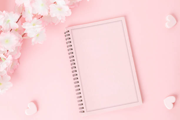 istock Pink notebook with flower on a pink background 1370505865