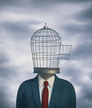 Businessman with a bird cage head. Mindset change and freedom concept. This is a 3d render illustration