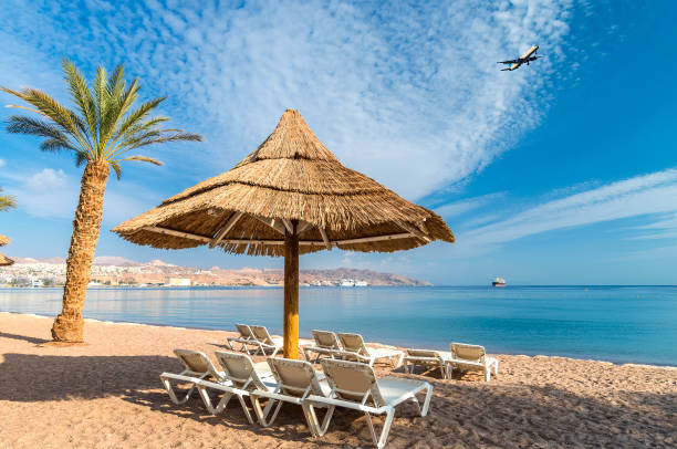 Central public beach of the Red Sea in Eilat Eilat is Israeli southernmost and famous resort tourist city, located on the northern shores of the Red Sea akaba stock pictures, royalty-free photos & images