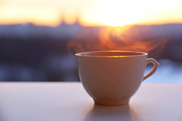 istock Hot coffee cup with smoke on sunshine background 1370507282