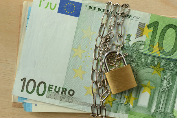 Closeup of euro banknote locked with chain and padlock - Stop cash concept stock photo