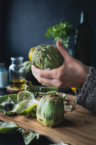 istock Cleaning and preparing artichokes in the kitchen. Cooking artichokes 1370508255