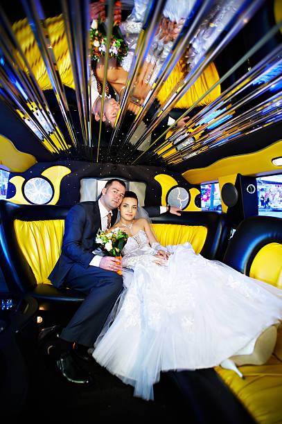 istock Bride and groom in wedding limousine 137051030