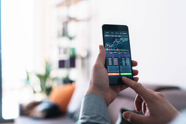 istock Businessman buying cryptocurrency through mobile phone app. 1370510864