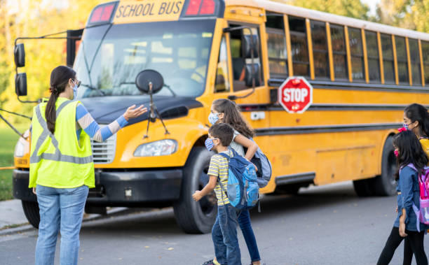 istock Crossing to the School Bus 1370511360